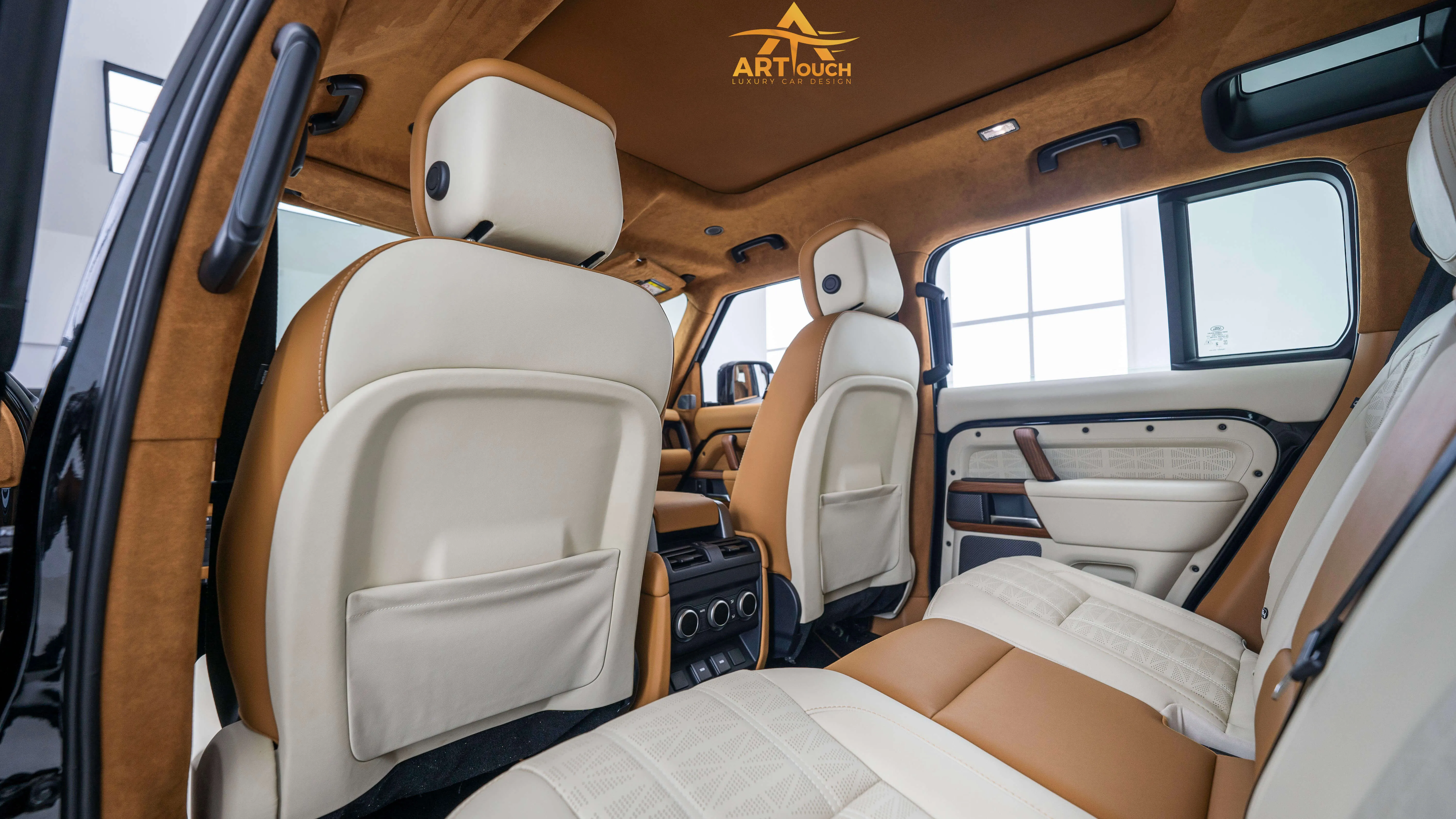 Bespoke Defender leather cabin. Premium Alcantara steering, custom gear knobs, and door panels crafted for a supreme luxury feel