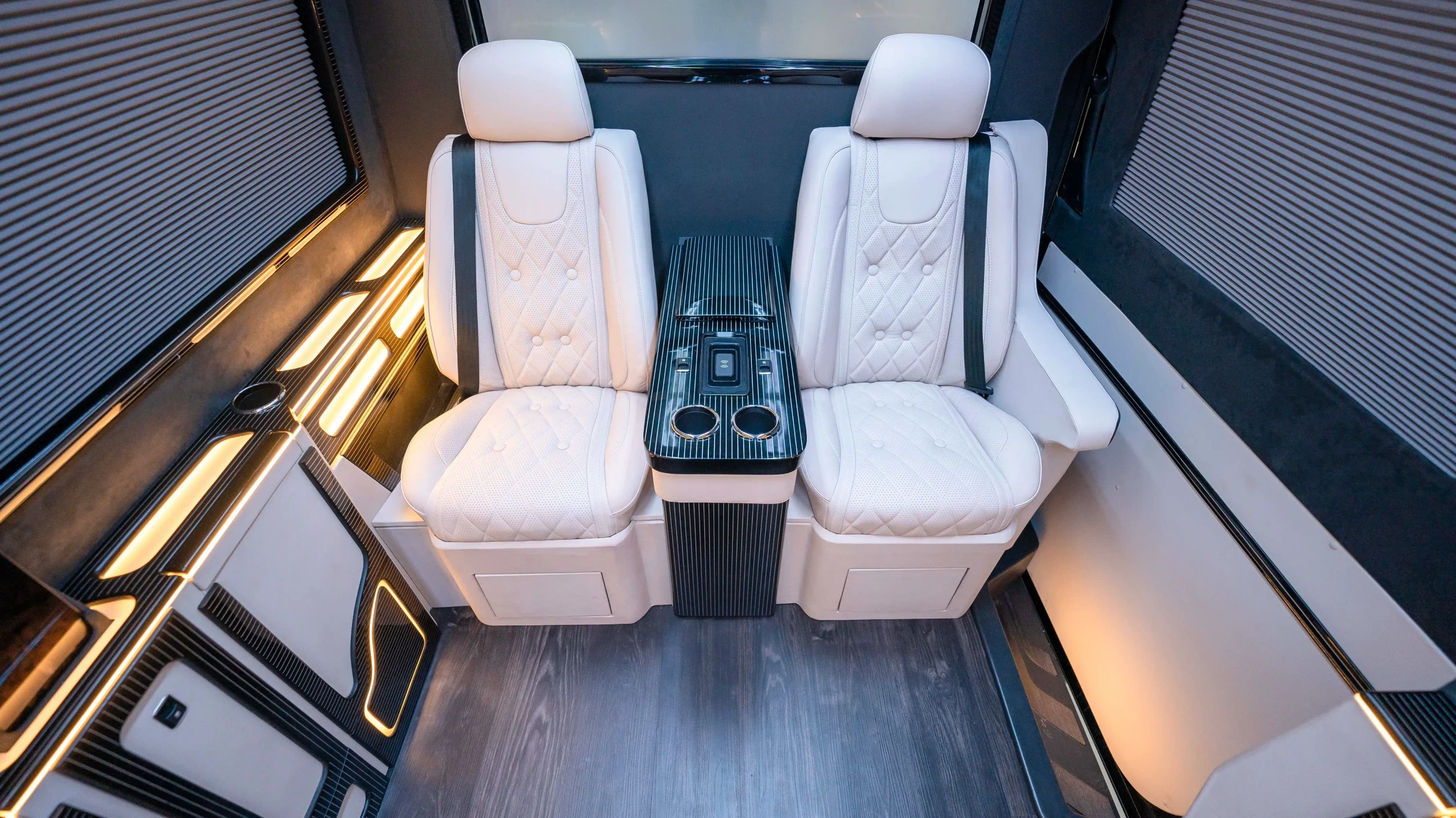 Bespoke Mercedes Sprinter VIP Interior in Dubai featuring White Leather, Black Alcantara, Executive VIP Seating and Luxury Van Customization